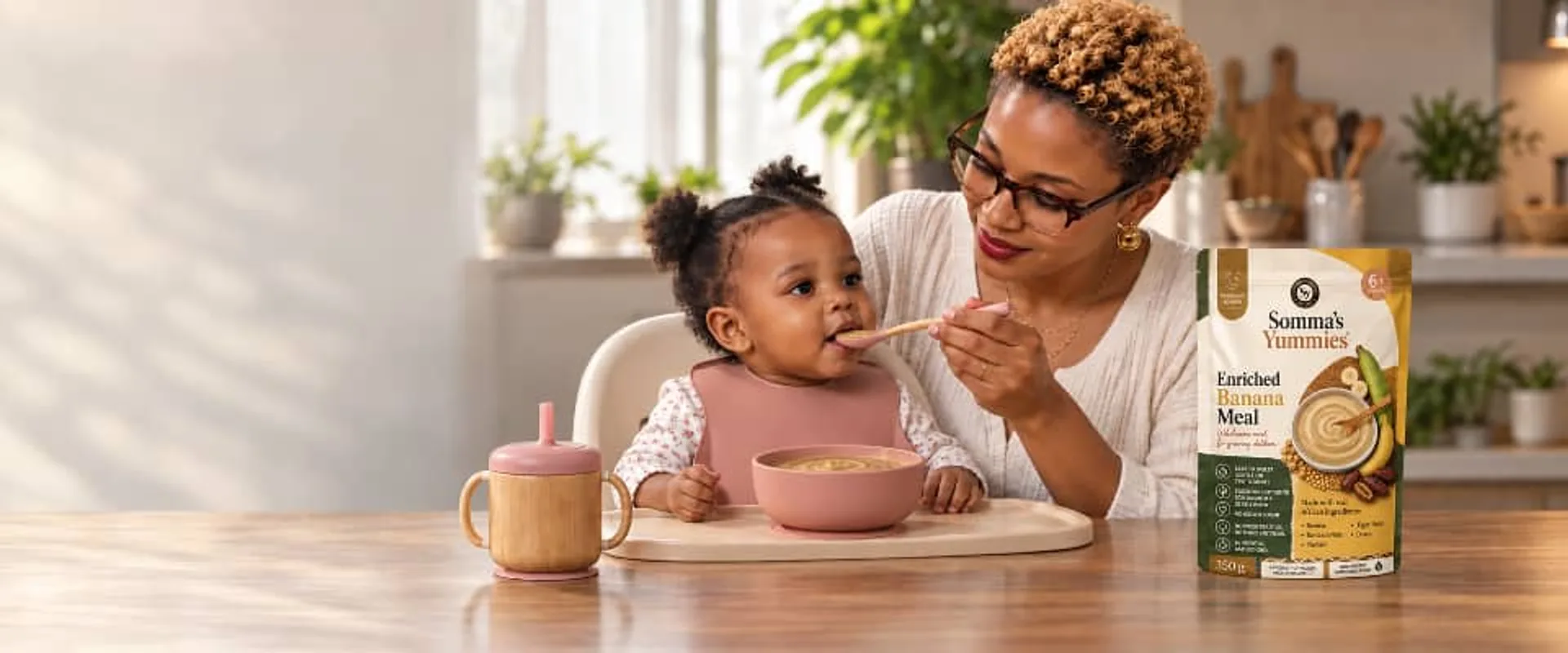 Nigerian mother and baby at feeding table